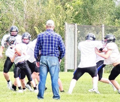Coach Todd Phelps looks on as the team practices.