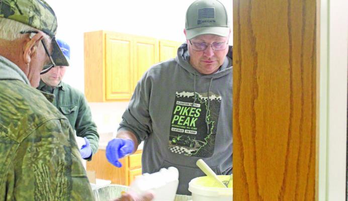 Duane Kimball puts a pile of breaded shrimp on the plate of one of the hundreds of dinner guests at Callaway’s Fish Fry on March 6. (Courier photos by Ellen Mortensen)