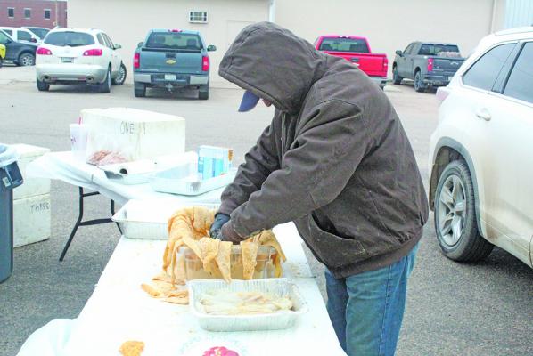 Members of the Knights of Columbus braved the chilly temperatures on Friday, March 6, to host the annual Fish Fry at the Callaway Community Center. Breading the fish is Mike Pandorf of Callaway.