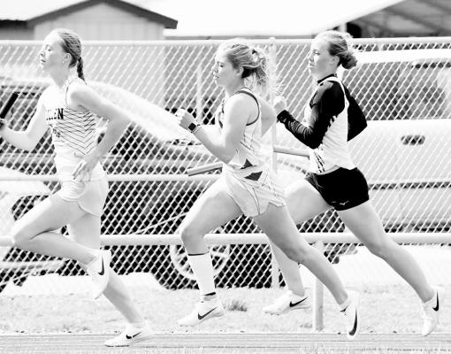 Erin Fitzgerald (center) runs her leg of the 4x400 relay helping her team to a 2nd-place finish with a time of 4:36.42 (Courier photos by Loleta Connell)