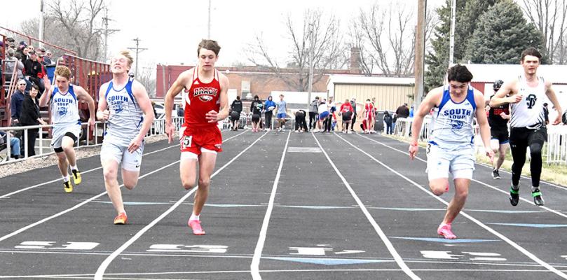 ABOVE: Dawson Mason fights through the strong winds in the 4x800 and the Bobcats earn silver clocking a 9:40.53. ABOVE RIGHT: Wacey Schultz, Trey Connell, and Conner Paulsen (L-R) compete in the 100m dash with Paulsen making finals and finishing 7th with a 12:39. (Courier photos by Loleta Connell)