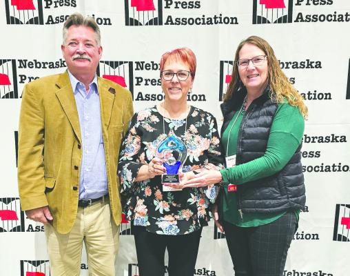 Courier and Leader Managing Editor Ellen Mortensen (center) and Courier and Leader Advertising Executive Loleta Connell accept the Omaha World Herald 2025 Service to Community award from Nebraska Press Association Board President Rob Dump during the NPA annual convention this past weekend. (Syndicate Publishing photo)