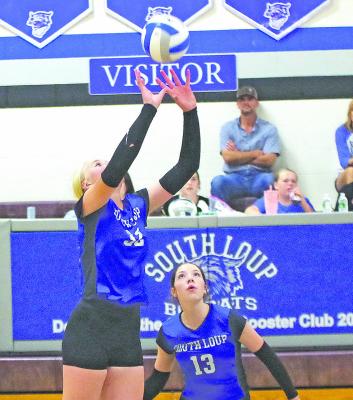 RIGHT: Emma Stallbaumer receives the ball as teammate Olivia Fitzgerald stands ready to assist during a match at the Bobcat's home triangular last week in Callaway.. (Courier photo by Ronda McFate)