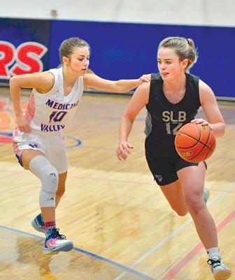 Junior Bryn Schwarz tries to dribble around a Medicine Valley defender.