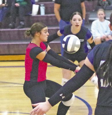 Charli Pandorf plays the ball while teammate Olivia Fitzgerald stands ready to assist if needed. ABOVE RIGHT: Gracie Brennan returns a ball