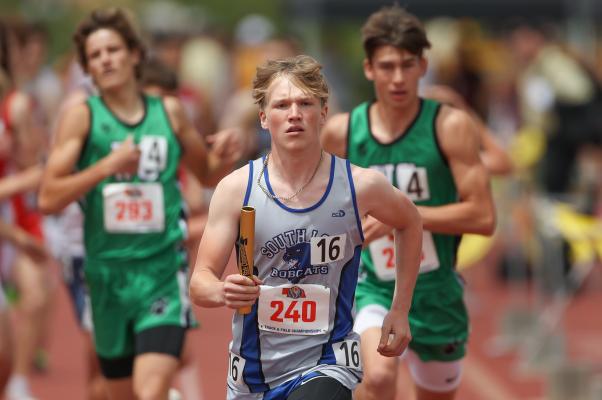 Trey Connell gets out with the baton during the 4 x 800 meter relay. (Courier photo by Corbey Dorsey)