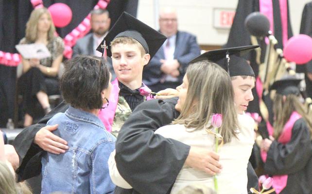 RIGHT: Maggie Birkel, far right, was the 2024 Valedictorian, while Josie Reiff, right, was the class salutatorian. Both gave their farwell addresses during the graduation ceremony on Sunday. LEFT: The traditional flower presentations during the graduation ceremony is always an emotinal moment for both graduates and loved ones, as the seniors use the time to give a special thanks to those who have helped them complete their journey at Callaway Public School.
