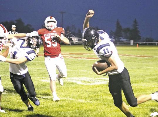 ABOVE: Dylan Pandorf fights for extra yards in South Loup’s season opener last week at Hemingford. The senior led the team in rushing with 60 yards on 17 carries for the night. LEFT: Tysen Schacher hones in on the pass from Pandorf. (Photos courtesy Melissa Eggleston)