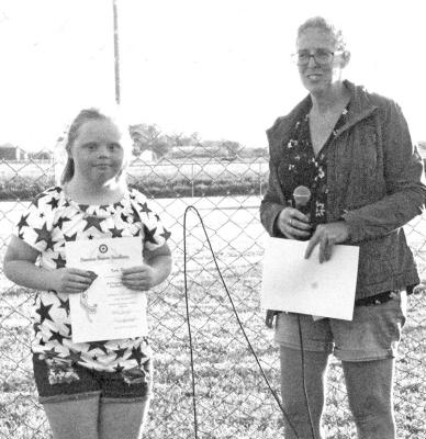 Katie Phelps receives her 1st place Poppy Poster award from Deondra Lashley. (Courier photo by Ellen Mortensen)