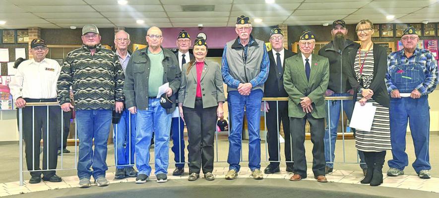 A number of Callaway-area veterans attended the program at Callaway Public Schools on Veterans Day, and posed for a photo with guest speaker Julie Schnitzler afterward.