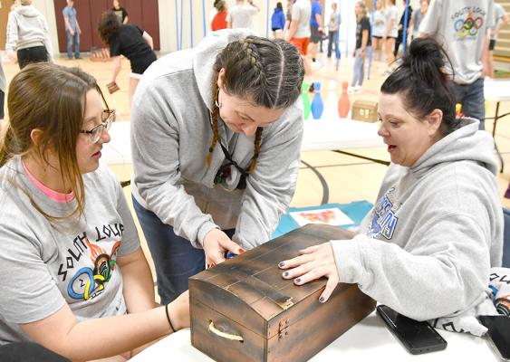 ABOVE RIGHT: The escape room treasure chest was a team effort! Pictured from left are, Tahnna Nokes, Jessica Tickle and Ronda McFate.