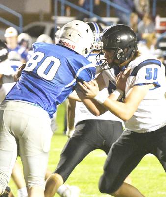 Kyle Bloomer (#50) blocks big against Chase Huffman in the Bobcats 58-18 win over Hyannis. (Courier photos by Loleta Connell).