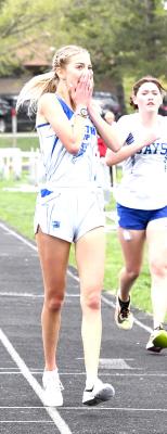 ABOVE: Logan Recoy finishes in second place and qualifies for the State Meet in the 800m run. LEFT: Ella Cool crosses the finish line and realizes she is a District Champion in the 2-mile. (Courier photos by Loleta Connell)