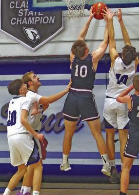Dylan Pandorf goes one-on-one to block the shot of the Hi-Line shooter on Feb. 13. Pandorf finished the game with 17 points and 11 rebounds. (Courier photos by Ronda McFate)