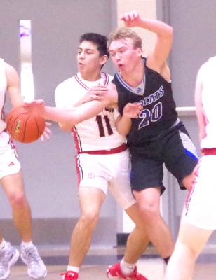 LEFT: AJ Starr goes after the ball against Sutton last week. ABOVE: Carter Wood tries to block a Sutton shot. RIGHT: Harper Johnson gets his hand on the ball as he defends a Sutton player in sub-district play. McFate, Starr, Wood, and Johnson all played their final game for South Loup on Feb. 25.