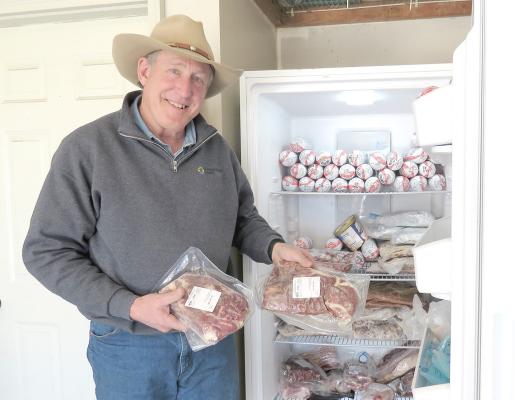 Rancher Jim Jenkins has a garage freezer full of steaks and ground beef at his log home north of Callaway. He was on his way to cattle working pens on the family's homestead site a few miles away on Jan. 28, 2025. (Photo by Lori Potter for the Flatwater Free Press)
