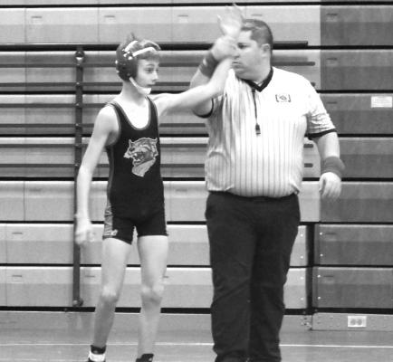 Noah Hiatt, South Loup’s 106-pound wrestler, has his hand raised in victory during the Southern Valley Duals on Dec. 15 (Courier photo by Brandy Mason)
