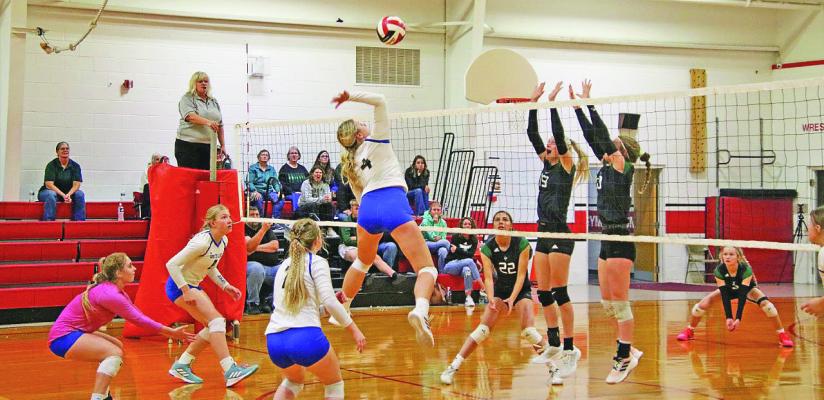 ABOVE: Taylor Ross goes up for a kill against Sandhills/Thedford on Saturday. BELOW: Abby Stallbaumer jumps at the net against West Holt on Saturday. Courier photos by Amanda Wehnes