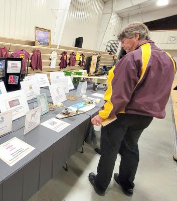 Rod Brestel got into the Maroon &amp; Gold Gala theme by donning his vintage Callaway Bears jacket Saturday night. Here he takes a few minutes to look over some of the auction items up for bid.