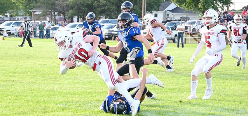 Dylan Pandorf wraps up the Hemingford ball carrier while Harper Johnson closes in to assist.