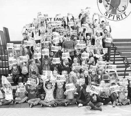 The elementary students showed their support for South Loup athlete Rio Remund as he signed to play football with Chadron State College. Remund can be seen standing in the middle of the kiddos. (Courier photos by Leta Connell)