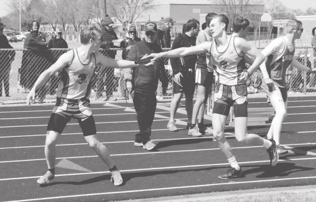 Cache Gracey hands off to Trey Connell for the first exchange during the 4x800 relay where the Bobcats brought home gold with a speedy time of 9:01.70. (Courier photo by Loleta Connell)