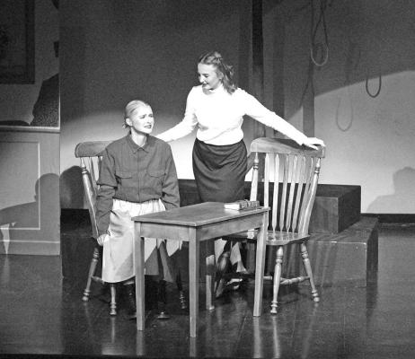 A reporter, played by Tiersa Johnson, conducts a post-war interview with concentration camp guard Greta, played by Chenney Dishman. (Courier photo by Ellen Mortensen)