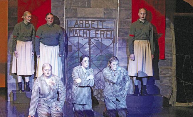 Back row, from left, guards Chenney Dishman, Ashly Denney, and Emma Stallbaumer keep the prisoners in line – kneeling, from left, Taryn Rohrbough, Olivia Fitzgerald, and Tyra Brestel.