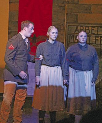 The Commandant, played by Caleb Furrow, gives firm instructions to Greta (Chenney Dishman) and Marga (Ashly Denney). (Courier photos by Ellen Mortensen)
