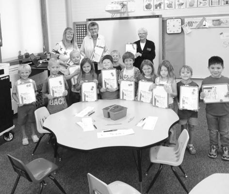 Shown are American Legion Auxiliary members, Jo Chesley and MaryAnn Boldt with kindergarten teacher Stephanie Ross and her class. One of the Auxiliary's yearly projects is offering to provide supplies to classrooms. White boards were suggested by the elementary staff and 30 boards were provided to be distributed to the elementary rooms. The Auxiliary also provided backpacks filled with school supplies to two elementary students. (Photos courtesy Jo Chesley)
