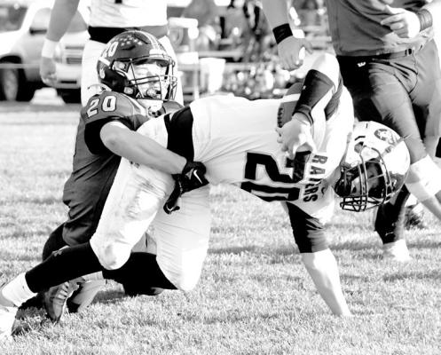 AJ Starr (#20) scoops up the Raider quarterback for a short gain on second down.