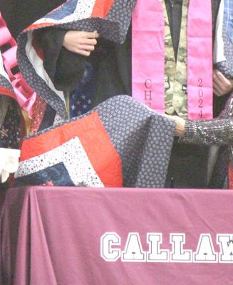 ABOVE: Jody Duplichan presented Quilts of Valor to 2024 CHS graduates Dylan Handley, left, and Brady Brestel during the graduation ceremony on May 12. RIGHT: Each quilt has a tag on the bottom corner with the name of the quilter and of the recipient. (Courier photos by Ellen Mortensen)