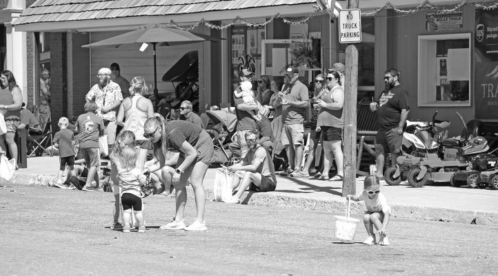 ABOVE: The parade always means candy for the littles, and they line Kimball Street with bags and buckets to hold their treasures. Some of the adults even tend to get in on the fun! Line-up for the 2025 parade will begin at 10 a.m. with the march down the street getting started at 10:45. This year's theme is '140 Years of Community'.