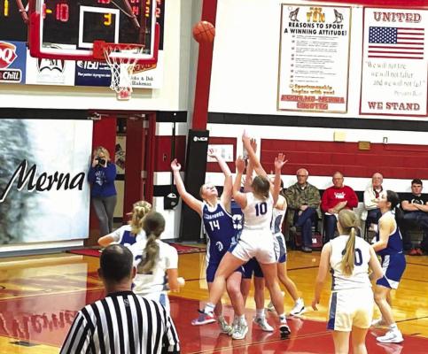 South Loup's Taylor Ross (#10) goes up strong against the defense and gets the shot off.