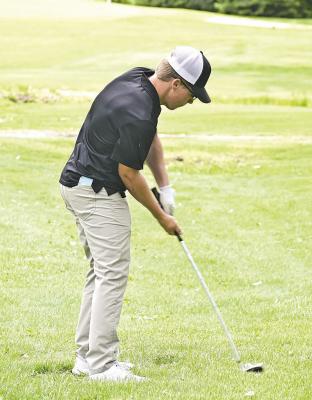  Brennan, a senior and first-year Bobcat golfer, concentrates on his shot during the district golf meet at Ainsworth. 