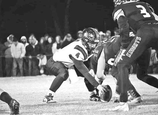 Senior Dawson Doggett snaps the ball in the D2 semi-final rematch Friday in Dunning. (Photo courtesy Jessica Tickle)