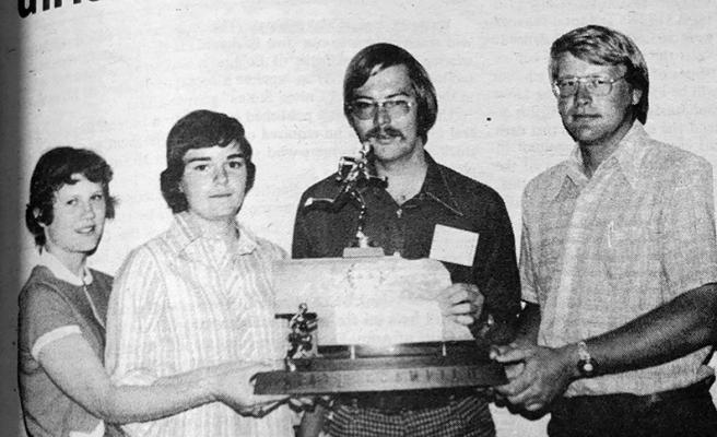 GIRLS CLAIM STATE TITLE: Holding the Class D State Champion trophy are Tami Leigh, Brenda Cantrell, Assistant Coach Leon May, and Coach Dave Aspegren.
