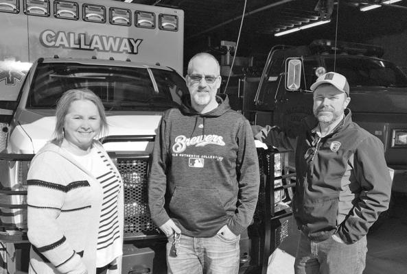 Standing in front of a Callaway ambulance are Tammy Weinman, Arnold Rescue Captain; Mark Buss, Callaway Rescue Chief; and Gail Reed, Ansley Rescue Captain. The three are part of a group working towards interlocal agreements between EMT units to help fill the void left by decreasing volunteers. (Photo by Mona Weatherly)