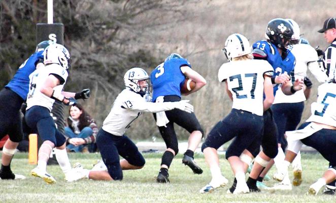 Quarterback Trey Connell (#3) hits the hole with #3 Junior Zaden Wolfe attempting to put a kabosh on the gain and it is 'Touchdown Bobcats'.