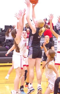 LEFT: Emma Stallbaumer goes over the top of the Hi-Line defenders as she attempts to take the ball to the hoop in last Friday's game.