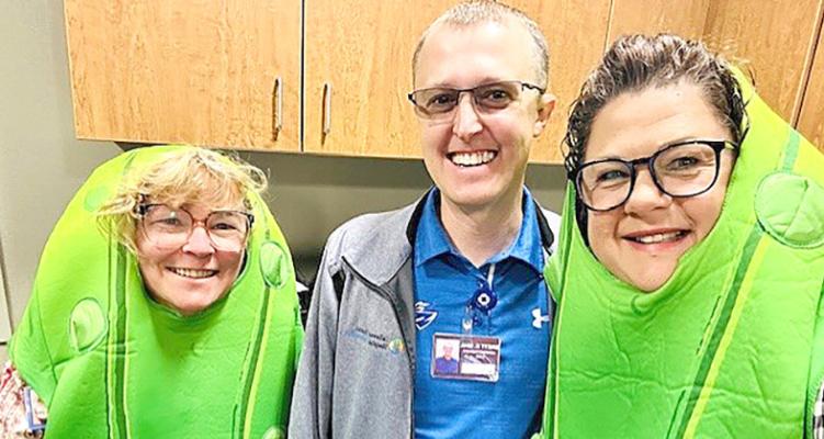 ABOVE: Senior Life Solutions 'pickles' Janel Brestel, left, and Kelly Herbig, right, pay a visit to Dr. Loper. Below: The 'pickles' visit Callaway District Hospital CEO Brett Eggleston. You have to use your imagination, but the ladies really are dressed in bright green pickle costumes to help raise awareness for mental helath. (Photos courtesy SLS)