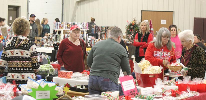 Above: Shoppers had a wide variety of items to select from during the home-based business and crafts show in the Callaway Community Center on Dec. 6. (Courier photos by Ellen Mortensen) Below: Janel Brestel, left, and Kelly Herbig were busy making S'mores while representing the Chamber in the mini-park which were enjoyed by children and adults alike.