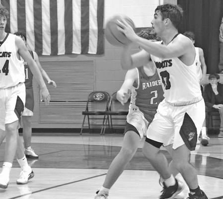 LEFT: Senior Conner Paulsen surveys the court for an open teammate (Courier photos by Loleta Connell)
