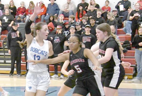 ABOVE: Sophomore EvaLynn Wonch asks for the ball as the Lady Bobcats in bounds the ball against the Mavericks. LEFT: Neltje Reiff stops Maverick #22 Hope Correll as she drives to the hoop and forces a pass. (Courier photos by Loleta Connell)