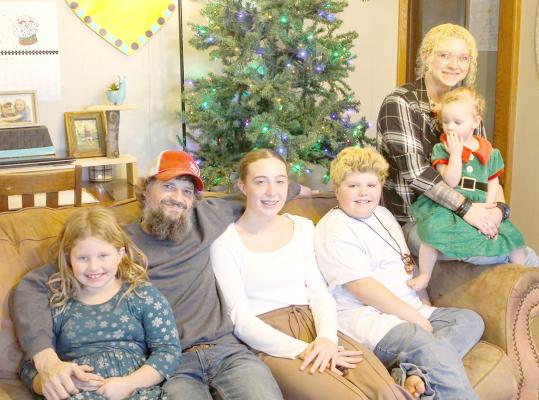 Marcus Blackburn and his fiance Jodie Wewel, and their children, lost their home in a fire on Feb. 10, but say they are grateful to the community for the support they have received. From left are Rayna, Marcus, Jaelynn, Couper, and Jodie holding Micaiya. (Courtesy photo)