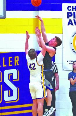 Malachi Neth goes up and over the top of S.E.M.’s Bode Martin for a basket in the Bobcats’ final regular season game last Friday. (Courier photos by Ronda McFate)