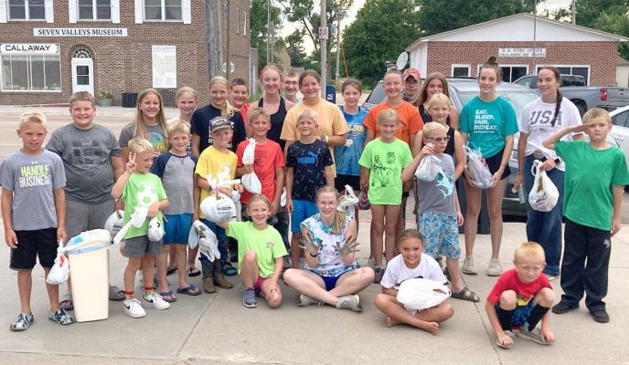 Senior 4-H member Josie Reiff (seated in the middle olding up her painted hands) organized a group tye dye project that was done on June 27. Here the kids are holding their bag that holds their freshly colored t shirts that they will take home to dry and then enter it at fair! (Photos courtesy Karla Pandorf)