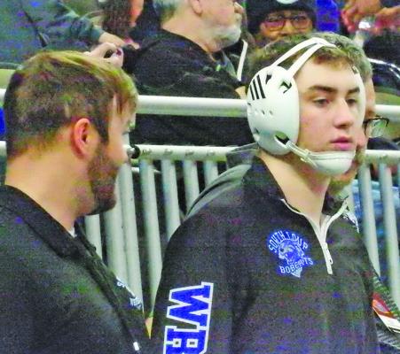 Paxton Bierman gets some pointers from his coaches prior to stepping on the mat at the Nebraska State Wrestling Championships in Omaha last week.