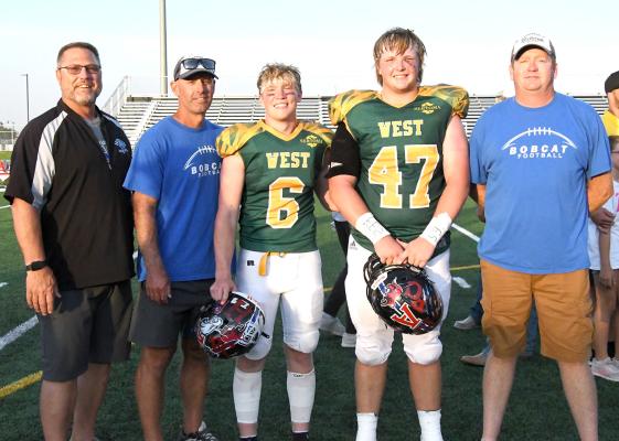 The coaches of the South Loup Bobcats football team stand proudly with the team's two 8-man All-Star selections. From left are Assistant Coach Mike Weverka, Assistant Coach Andy Schwarz, Trey Connell, Joey Sallach, and Head Coach Mat Jageler.