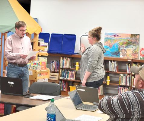 Callaway School Board President Mike Reiff presented the oath to new member Rebecca Eggleston as she was sworn in to serve on the school board at the Monday, April 8 meeting. (Courier photo by Ellen Mortensen)